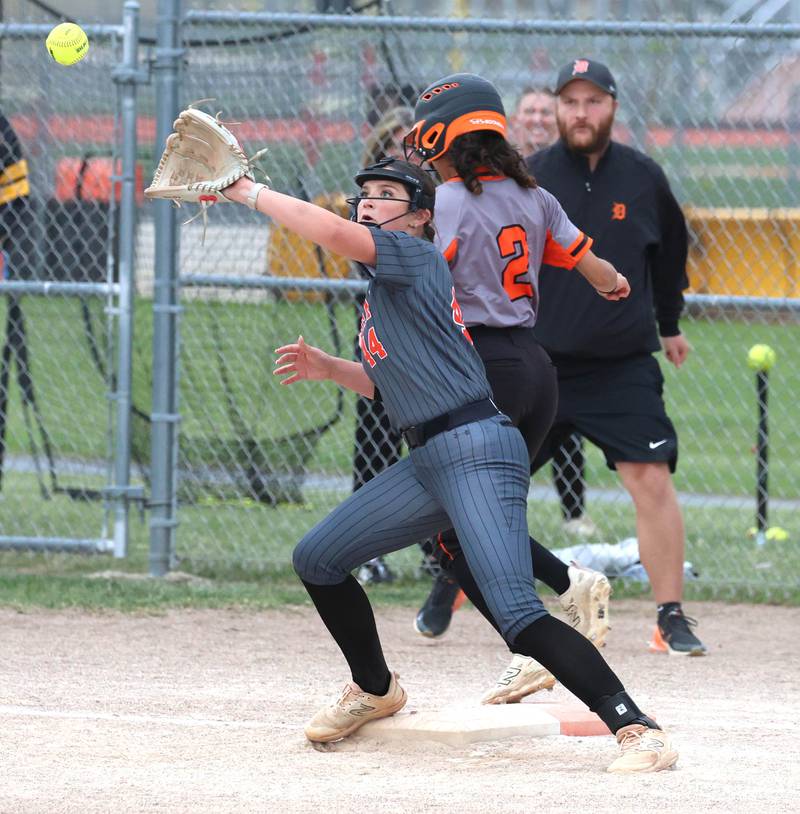 DeKalb's Nazeria Dean beats out an infield single as Harlem's Molli Hawkinson takes the throw Tuesday, May 19, 2026, during their Class 4A regional game at DeKalb High School.