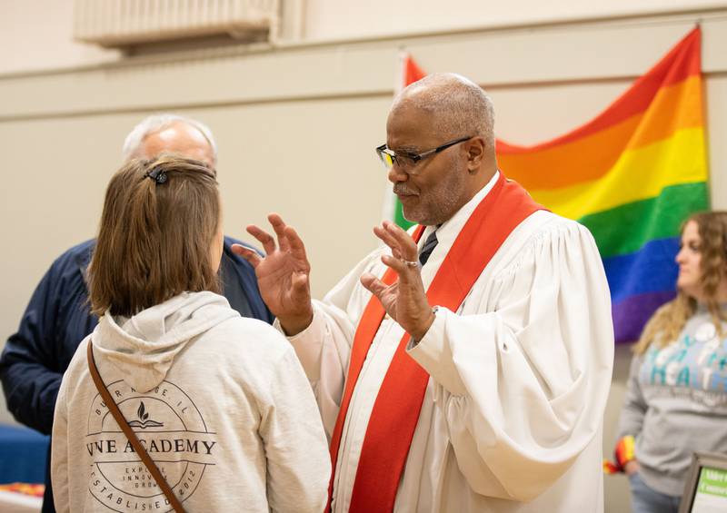 First United Methodist Church of Downers Grove (FUMCDG)  Pastor Claude King talks to an attendee during Pride in the Parking Lot hosted by Equality Downers Grove and the FUMCDG at the First United Methodist Church of Downers Grove on Sunday, June 11, 2023. The celebration was moved inside the church due to weather.