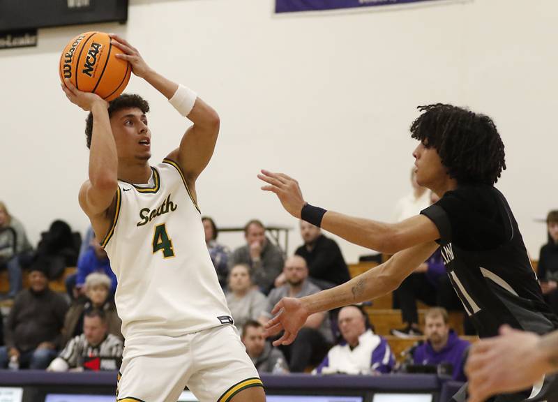 Crystal Lake South's AJ Demirov shoots the ball over Kaneland's Evan Frieders during the IHSA Class 3A Rochelle Sectional championship basketball game on Friday, March 7, 2025, at Rochelle High School.
