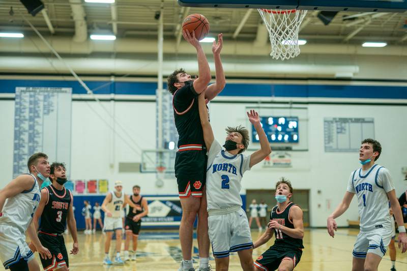 Wheaton Warrenville South's Tyler Fawcett (23) shoots the ball in the post over St. Charles North's Mason Siegfried (2) during a basketball game at St.Charles North High School on Friday, Jan 21, 2022.