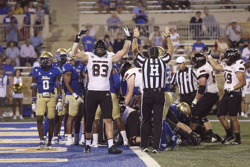 NIU tight end Liam Soraghan indicates a touchdown next to a ref doing the same in the Huskies' 38-35 loss to Tulsa on Sept. 10, 2022 in Tulsa, Oklahoma.