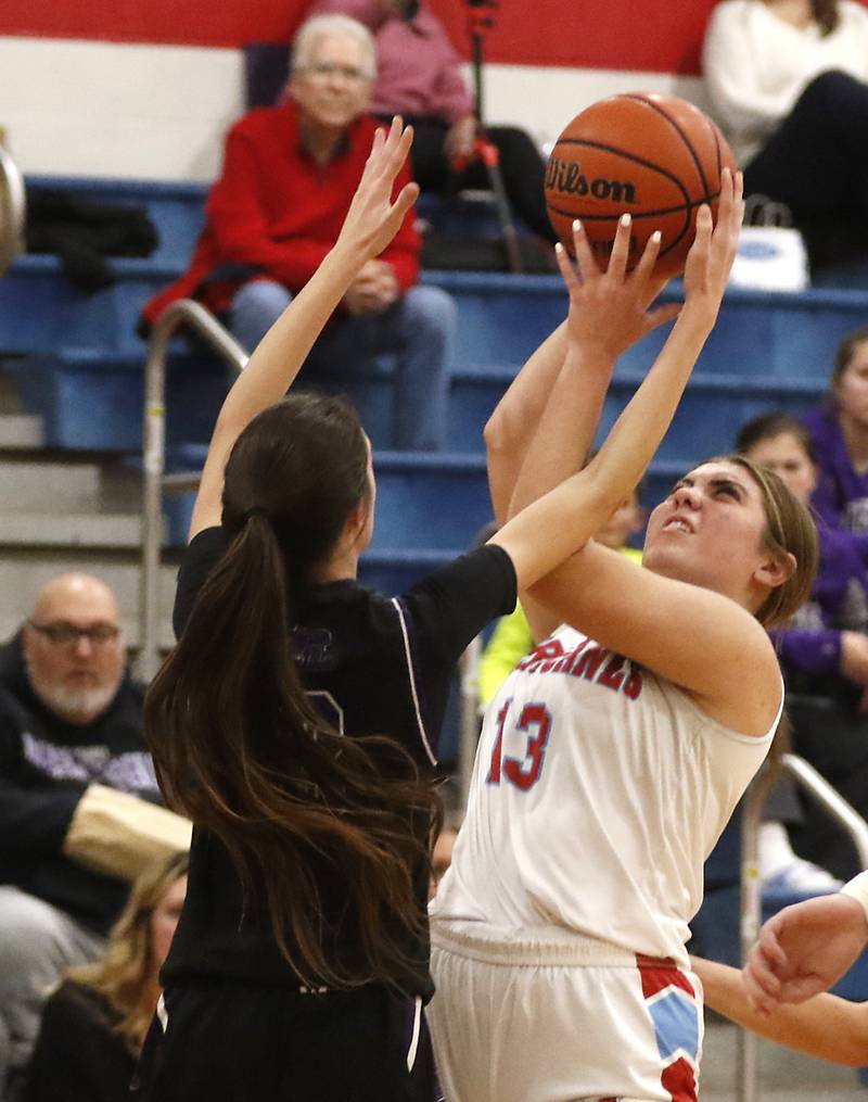 Marian Central's Lucy Iden tries to grab a rebound in front of Rockford Lutheran's Kaylee Bankes during a non-conference girls basketball game Monday, Dec. 12, 2022, between Marian Central and Rockford Lutheran at Marian Central Catholic High School, in Woodstock.