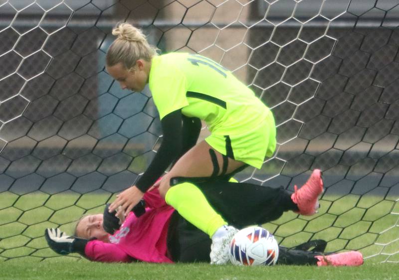 Marengo’s goalkeeper Macy Noe gets tangled up with Richmond-Burton’s Maddie Seyller in IHSA Class 1A Regional Title Game action soccer at Marengo High School in Marengo on Wednesday, May 21, 2025.