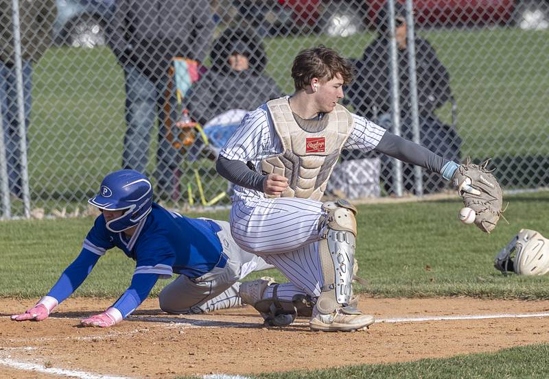 Princeton’s Hunter Spiegel slides in safe at home against Newman Monday, April 6, 2026.
