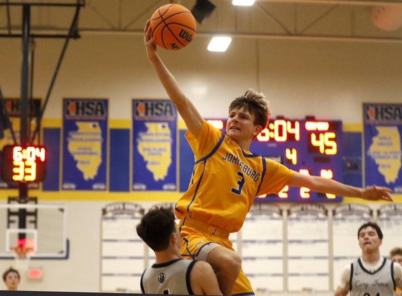 Johnsburg's Trey Toussaint drives to the basle against Cary-Grove's Dylan Dumele during a Johnsburg Thanksgiving Tournament boys basketball game on Monday, Nov. 24, 2025, at Johnsburg High School.