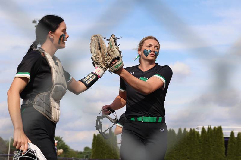 Seneca pitcher Tessa Krull and catcher Brynlee Hunt tap gloves after securing three outs during Seneca's 11-1 victory over Manteno on Friday, May 8, 2026.