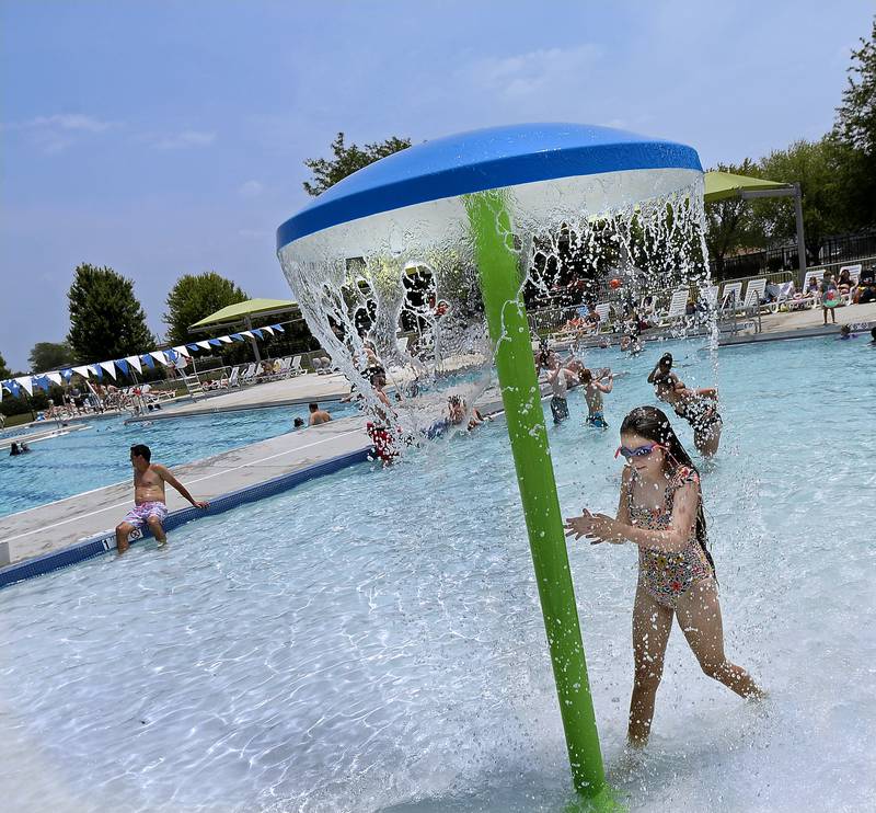 Swimmers at the new Riordan Pool cool off in the zero-foot entry part of the pool Monday, June 19, 2023.