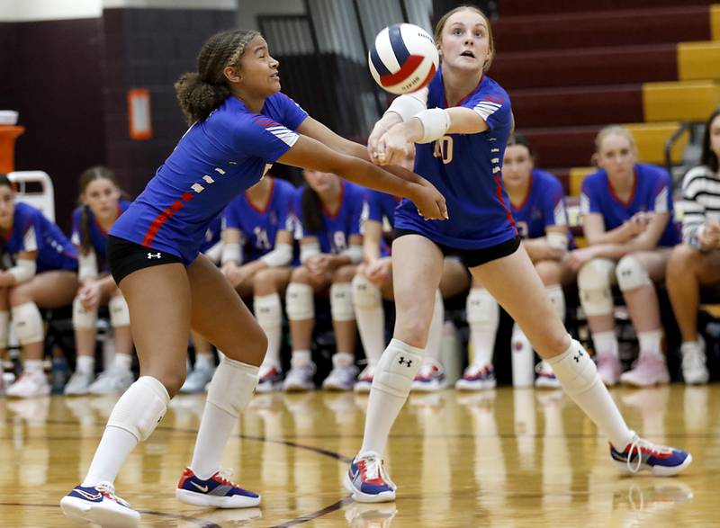 Lakes’ Brynn Skinner (left) and Isabel Stauber  (right) almost cloud as then pass the ball forward during a nonconference volleyball match against Richmond-Burton on Monday, Sept. 29, 2025, at the Richmond-Burton High School in Richmond.