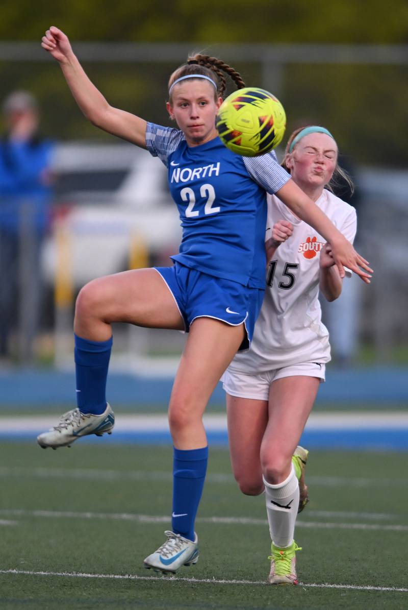 Wheaton North’s Casey Kenny, left, directs the ball away from Wheaton Warrenville South’s Eleanor Whaley during Thursday’s girls soccer match at Wheaton North.