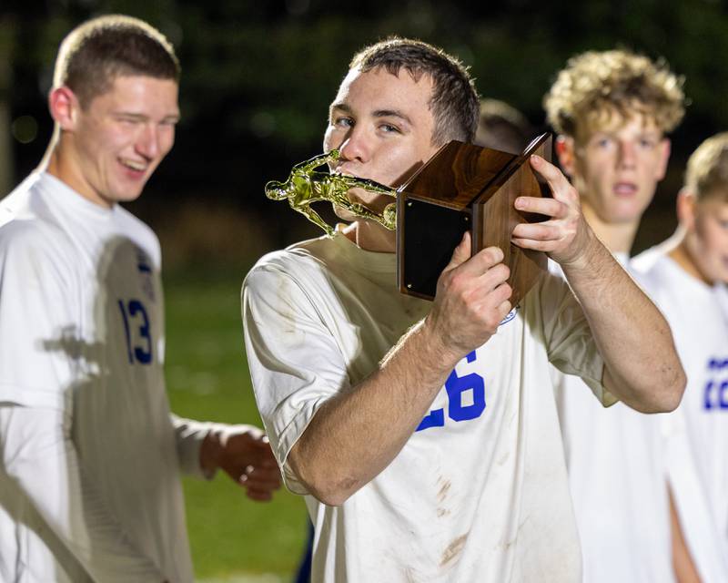 Austin Kennedy (26) of Hinckley-Big Rock kisses trophy after winning the Little Ten Conference Championship match against Somonauk/Leland/Newark on Thursday, Oct. 9, 2025 at Hinckley-Big Rock School in Hinckley.