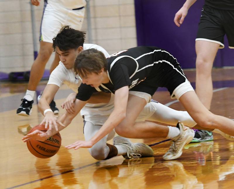 Dixon's Wyatt Wetzell (11) and Byron's Ryan Tucker (10) dive for a loose ball for during Big Northern Conference action on Tuesday, Jan. 31 at Lancaster Gym in Dixon.