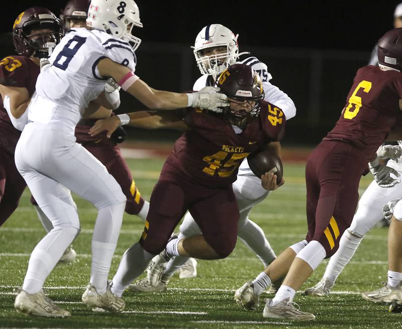 Richmond-Burton's Braxtin Nellessen breaks through the line as St. Viator's Jr Clary grabs him during a IHSA Class 4A first round playoff football game Friday, Oct. 27, 2023, at Richmond-Burton High School in Richmond.