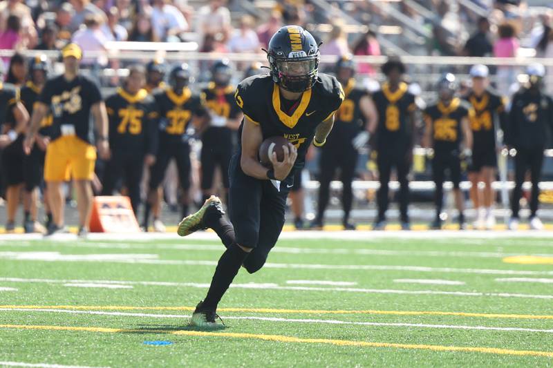 Joliet West’s Alexander Cruz scrambles out of the pocket against Joliet Central on Saturday, Sept. 23, 2023 in Joliet.