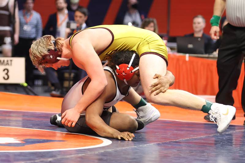 Lockport’s Andrew Blackburn-Forst works over Marist’s Ghee Rachal in the Class 3A 220lb. championship match at State Farm Center in Champaign. Saturday, Feb. 19, 2022, in Champaign.