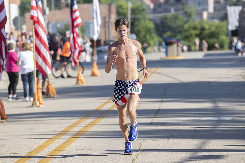 Tommy Murray takes the checkered flag in the Reagan Run 5K on Saturday, July 6, 2024, with a time of 15:12.27.