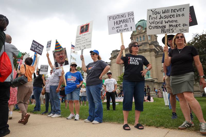 Protesters hold signs as approximately 500 people gathered at the Kankakee County Courthouse for a ‘No Kings’ rally in Kankakee on Saturday, June 14, 2025, to protest actions by President Donald Trump.