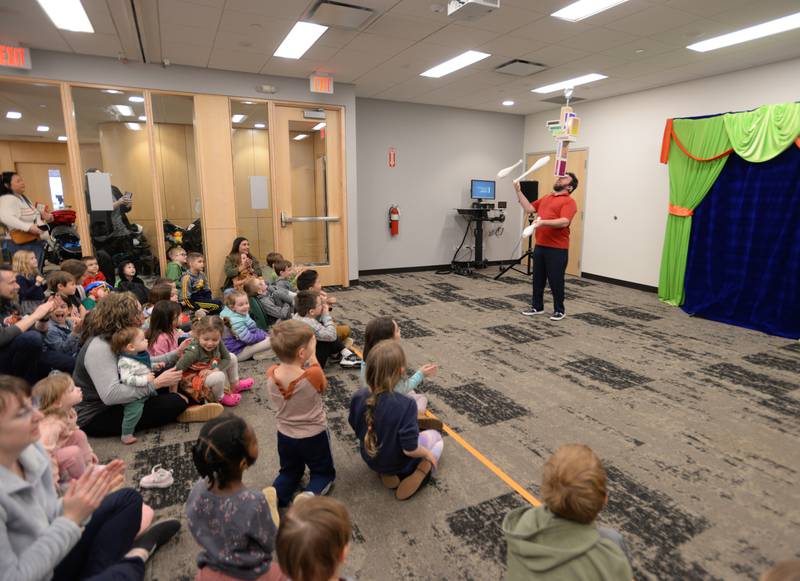 Jason Kollum demonstrates how to juggle during the See a Juggler, Be a Juggler held at the Glen Ellyn Library Saturday April 5, 2025.