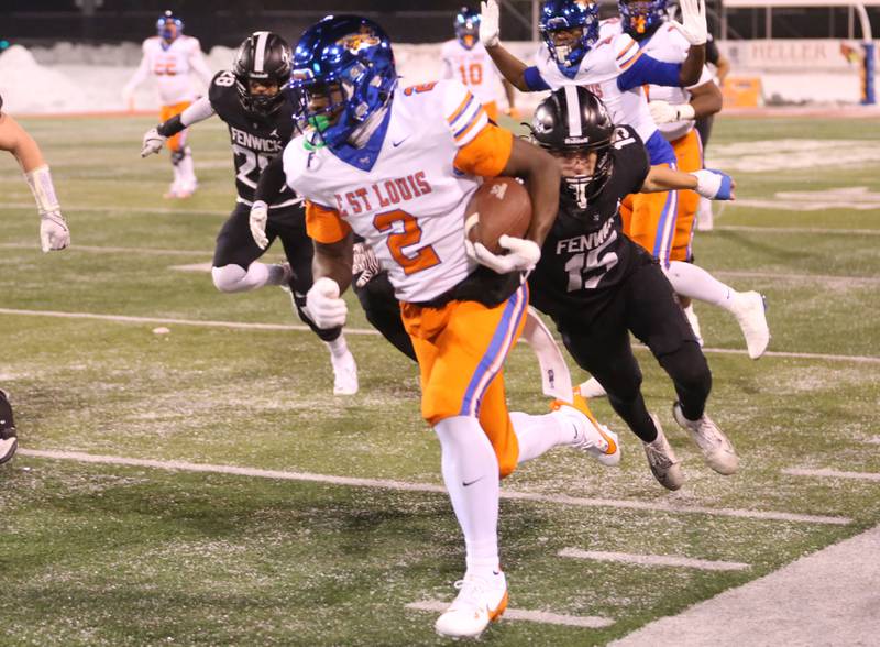 East St. Louis's Josh Morgan runs with the ball past Fenwick's Fran Madden during the Class 6A State championship game on Tuesday, Dec. 2, 2025 in Hancock Stadium at Illinois State University in Normal.