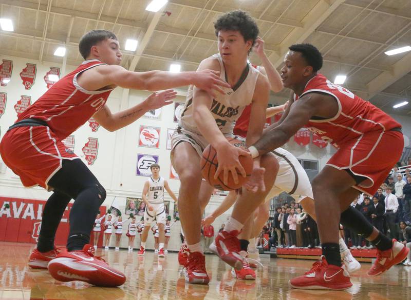 L-P's Michael Hartman runs in the lane as he is guarded by Ottawa's Huston Hart and Tristin Finley on Friday, Jan. 5, 2023 at Sellett Gymnasium.