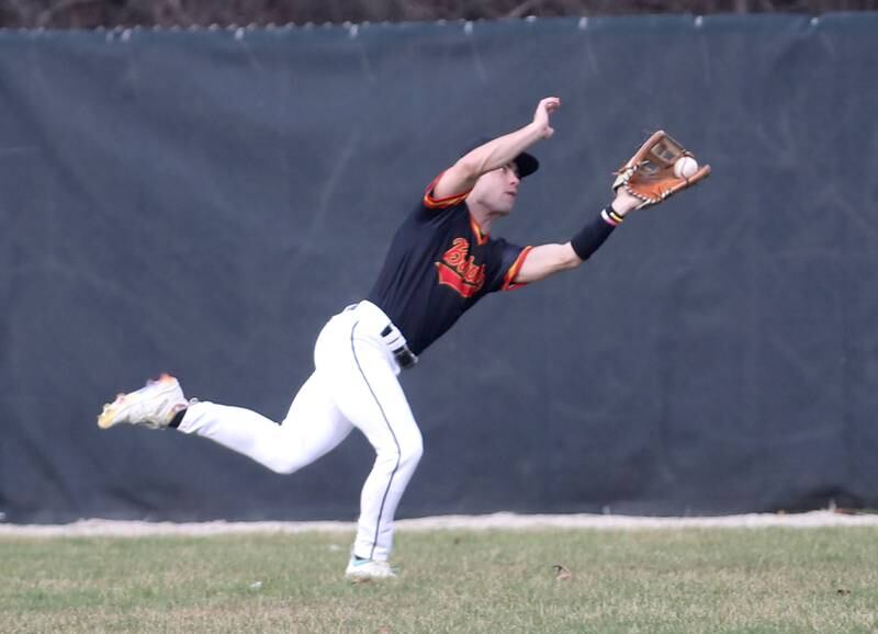 Batavia’s Katcher King makes a diving catch in right field during a game against Glenbard West at Village Green Park in Glen Ellyn on Wednesday, March 13, 2024.