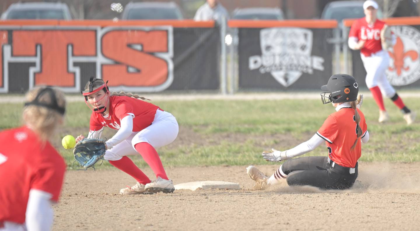 St. Charles East’s Morgan Beers slides safely into second base as Lincoln-Way Central’s Ellie McLaughlin waits for the throw in a softball game in St. Charles on Tuesday, Mar. 24, 2026.