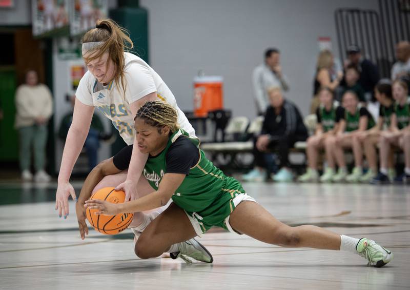 Bishop McNamara's Eliana Isom, front, and Joliet Catholic's Emma Birsa, back, compete for a loose ball during the Class 2A Regional Championship on Thursday, Feb. 19, 2026.
