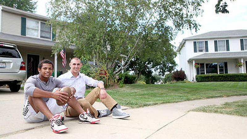 Batavia senior Anthony Scaccia (left) relaxes with his older brother, Andrew, outside their home. Anthony, who was adopted at age 8, is one of four Scaccia siblings.