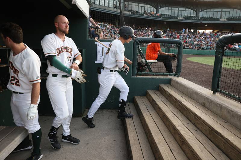 Joliet Slammers’ Carson Maxwell, right, heads out to the batting circle during the game against the Ottawa Titans. Friday, May 13, 2022, in Joliet.