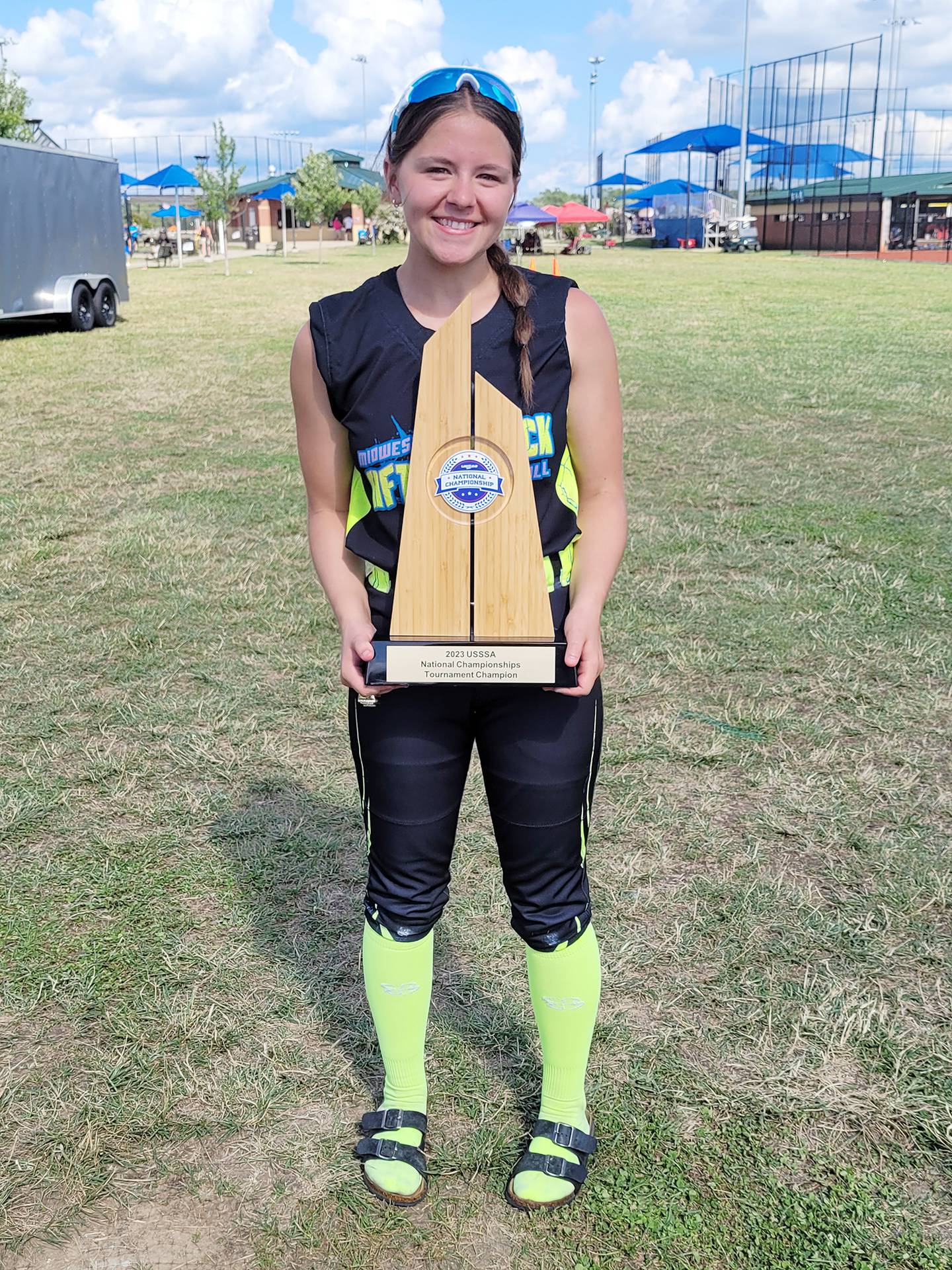 Polo's Cheyenna Wilkins poses with the championship trophy after the Midwest Aftershock 16U won the title at the USSSA Great Lakes Nationals in Evansville, Indiana.