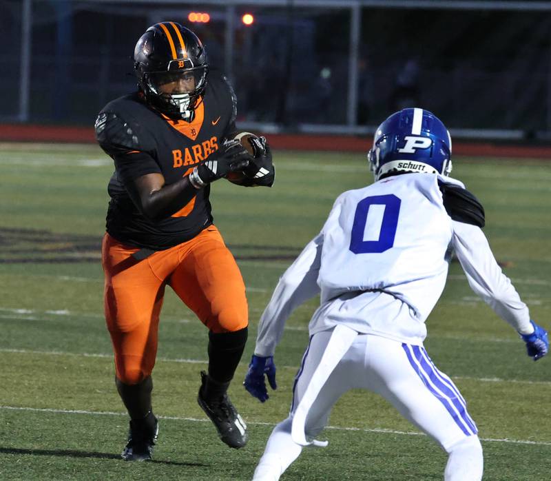 DeKalb's Travis Moore looks to run through Phillips' Rahshard Jordan Friday, Sept. 5, 2025, during their game at DeKalb High School.