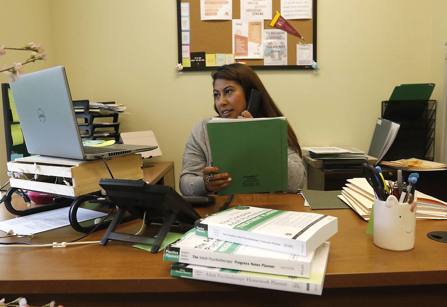 Jaret Ross, a social worker with Family Health Partnership Clinic, talks on the phone as works with a client Thursday afternoon, Sept. 28, 2023. Social services agencies like the Family Health Partnership Clinic asking the county for more money for mental health treatment as part of the county's 2024 budget.