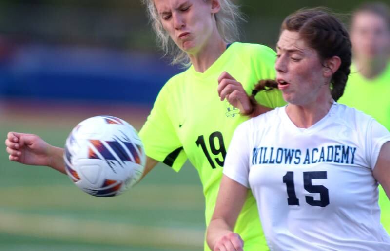 Richmond-Burton’s Layne Frericks, left, battles Willows’ Veronica Presberg in Class 1A Sectional title soccer action at Richmond Friday night.