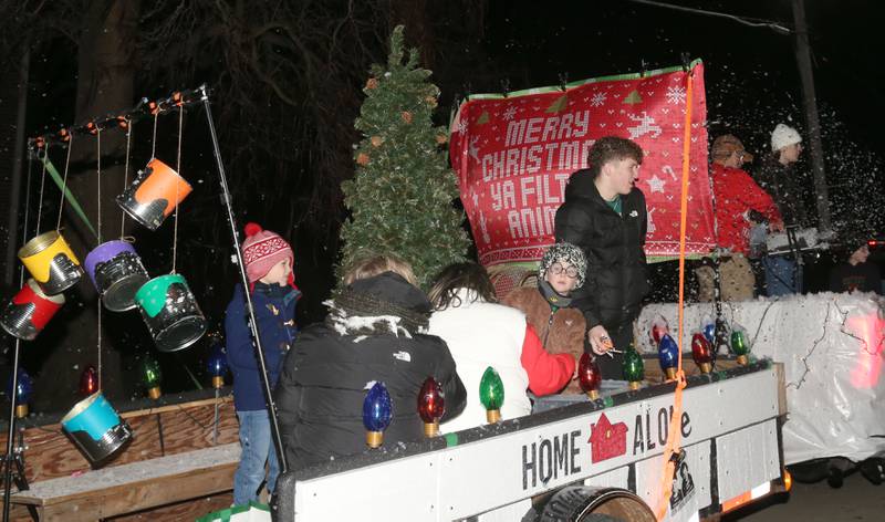 A "Home Alone" themed float travles during the annual Christmas Parade on Saturday, Dec. 7, 2024 on Peoria Street in Peru.