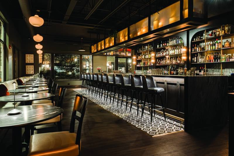 From the custom wine wall to the banquette seating along the windows, the team found creative ways to insert function, such as storage space, within the beautiful design.