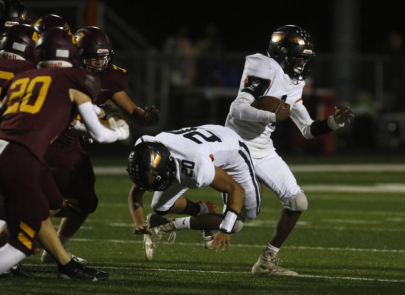 Sandwich's Simeion Harris tries to get around his teammate, Diego Gomez, as he gets knocked down by the Richmond-Burton defense during a Kishwaukee River Conference football game on Friday, Oct. 4, 2024, at Richmond-Burton High School.