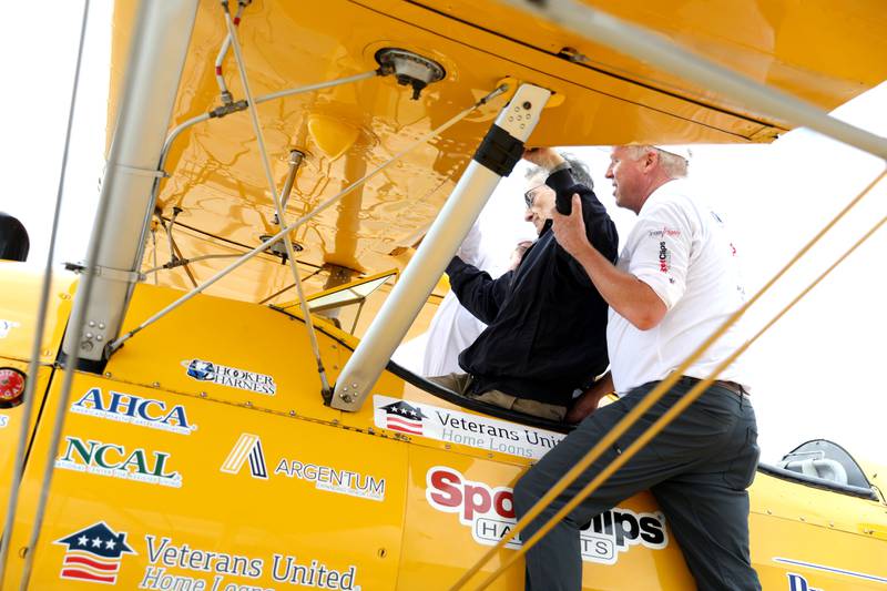 Guy Prisco, 93, a resident of Covenant Living at the Holmstad in Batavia, is eased into his seat for a Dream Flight at the DuPage Airport in West Chicago on Saturday, July 29, 2023. The plane is a 1942 open cockpit Boeing Stearman, the same airplane used to train military aviators in the 1940s. The flights were courtesy of Ageless Aviation Dreams Foundation, a non-profit organization to honor U.S. military veterans living in long-term care facilities. Prisco was a First Lieutenant with the Army Corps of Engineers in the 1950s.