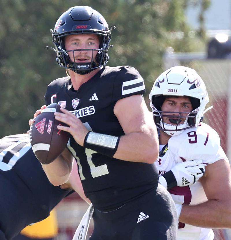 Northern Illinois' Rocky Lombardi looks for a receiver as he is pressured by Southern Illinois' DJ Johnson during their game Saturday, Sept. 9, 2023, in Huskie Stadium at NIU in DeKalb.