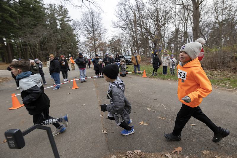A trio of young runners make the hairpin turn to head down the hill Thursday, Nov. 28, 2024, at Lowell Park in Dixon. 260 people signed up for this year’s St. Anne’s Turkey Trot 5K.