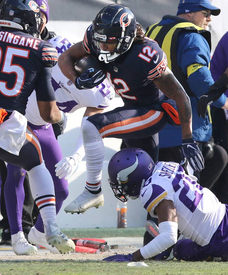 Chicago Bears wide receiver Velus Jones Jr. hurdles Minnesota Vikings cornerback Duke Shelley on his way to a touchdown Sunday, Jan. 8, 2023, during their game at Soldier Field in Chicago.