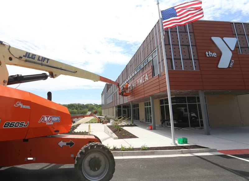 Crews install letters spelling "Ottawa YMCA" on Monday, May 6, 2024 at the new YMCA in Ottawa.