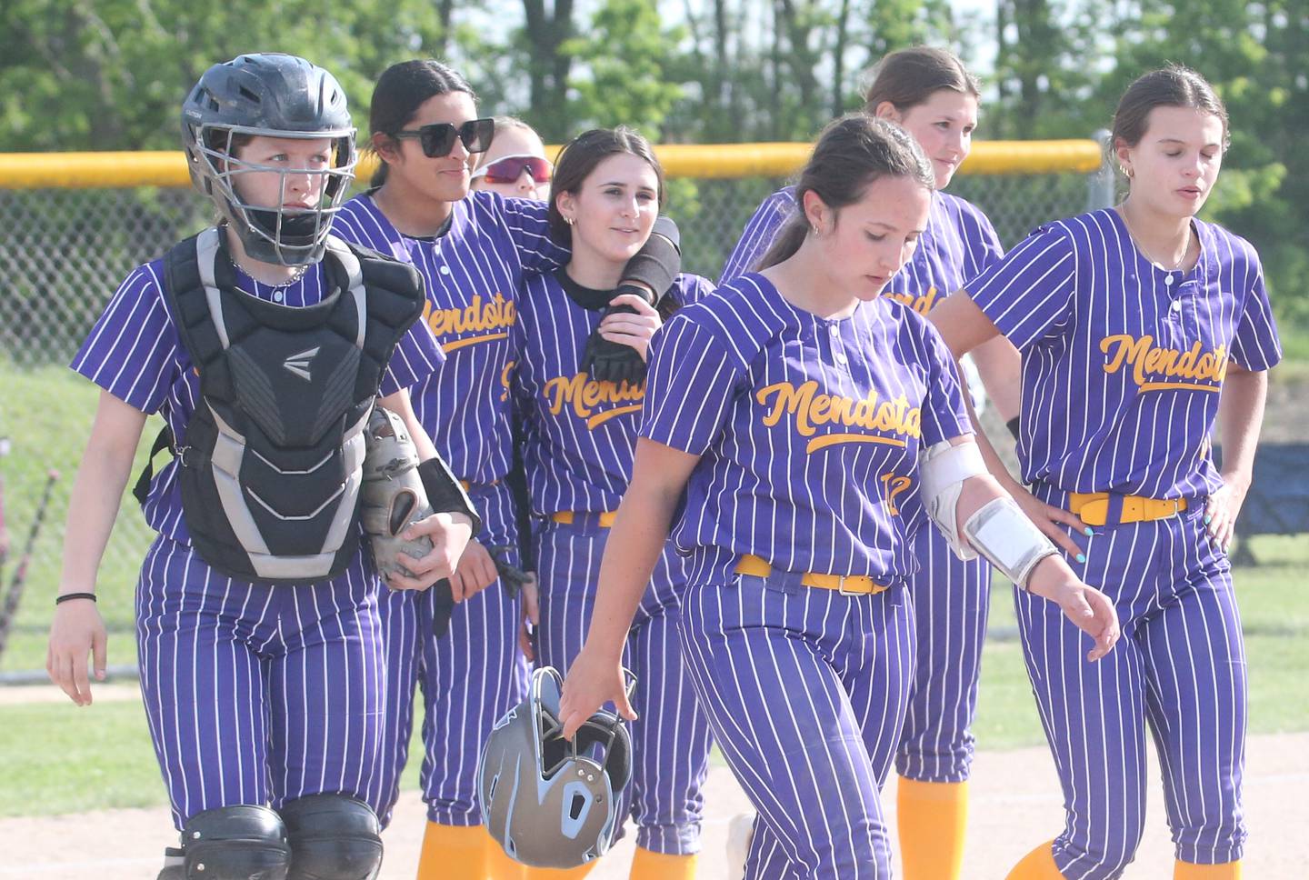 Members of the Mendota girls softball team walk off the field after falling to Somonauk/Leland during the Class 1A Regional quarterfinal game on Monday, May 19, 2025 at Somonauk High School.
