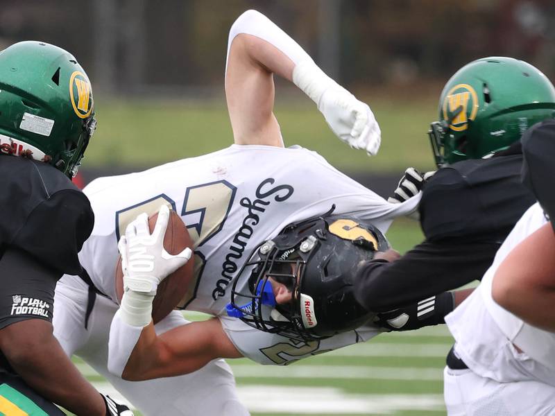 Sycamore's Dylan Hodges is pulled down by a Westinghouse defender Saturday, Nov. 9, 2024 during their Class 5A second-round playoff game at Knute Rockne Stadium in Chicago.