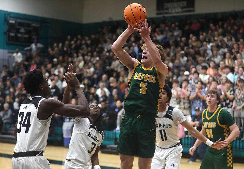 Crystal Lake South's Carson Trivellini shoots the ball against Kaneland’s Jeffery Hassan, (left) to right0 Marshawn Cocroft, and Evan Frieders during the IHSA Class 3A Woodstock North Sectional final basketball game on Friday, March 6, 2026, at Woodstock North High School.