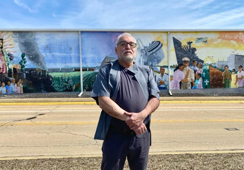 Chicago artist Robert Valadez, shown  here in a March 2022 photo, is returning to Sterling in mid-August to restore the mural Adelante, which he painted in 1999. Donations are being sought to help with the effort.