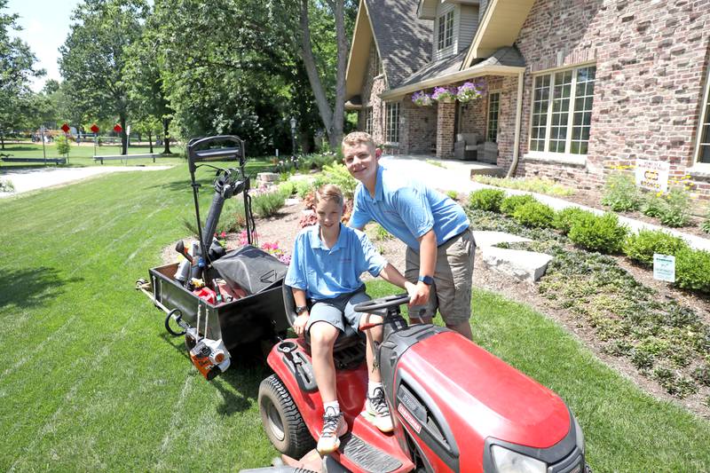 Brothers Nathan, 14, (right) and Colin Humphrey, 12, of Downers Grove, who run Two Brothers Landscaping, have received support Downers Grove businesses to provide screen-printed shirts and business merchandise as well as help repairing their lawn equipment.