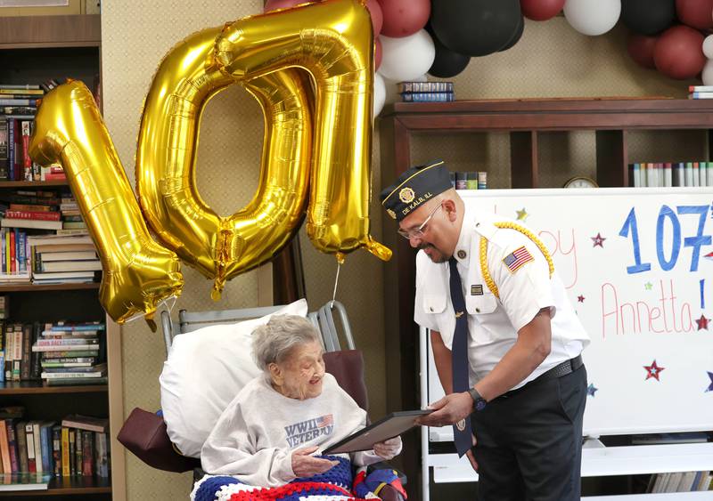 Manuel Olalde, post commander for DeKalb American Legion Post 66, presents World War II veteran Myrtle Annetta Lusiak a certificate of honor Thursday, May 2, 2024, during her birthday celebration at Aperion Care in DeKalb. Lusiak, who was honored Thursday with gifts and proclamations, turned 107-years-old and served in the Women’s Army Corps from Aug. 5, 1943 until her honorable discharge on Nov. 27, 1945.