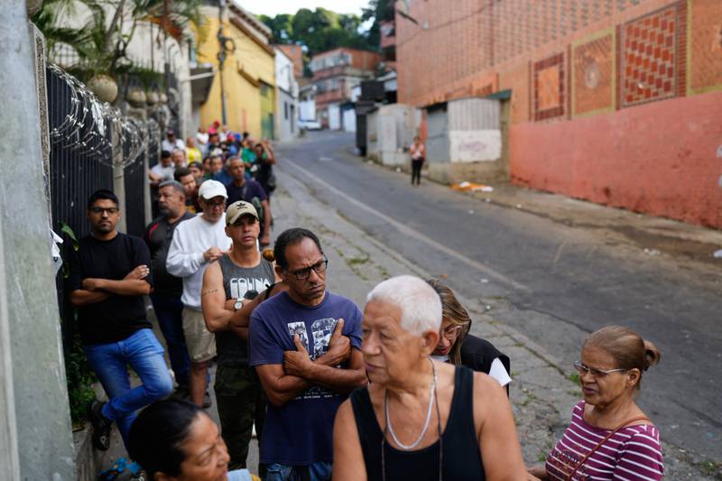 Shoppers line up at a supermarket in Caracas, Venezuela, Sunday, Jan. 4, 2026. (AP Photo/Ariana Cubillos)