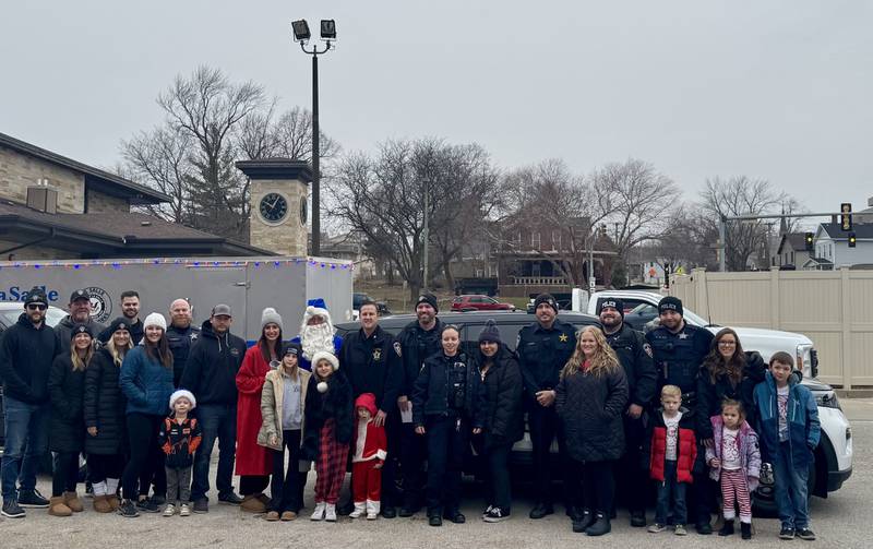 Officer Santa and his helpers pose for a picture before delivering gifts to more than 100 kids on Saturday, December 14, 2024.