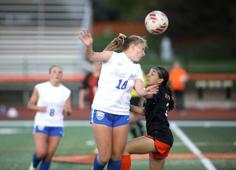St. Charles North’s Chloe Kirsten heads the ball during a Tri-Cities Soccer Night game against St. Charles East on Tuesday, April 29, 2025 in St. Charles.