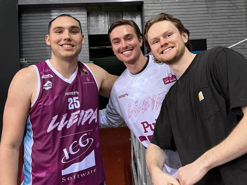 Jacobs gradaute Cameron Krutwig (left) with former high school teammates Cooper Schwartz (middle) and Mason Materna (right) at a ICG Forca Lleida game in Spain's LEB Oro this season.